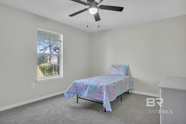 carpeted bedroom with baseboards, a textured ceiling, and ceiling fan