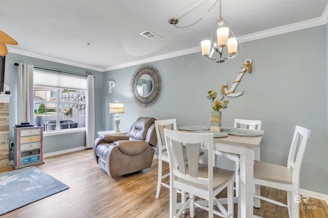 1517 Regency Rd Unit 121, Gulf Shores, AL 36542 - dining area featuring crown molding, wood finished floors, and baseboards