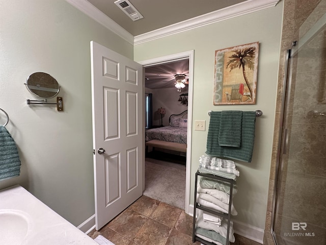 1517 Regency Rd Unit 121, Gulf Shores, AL 36542 - bathroom with ornamental molding, connected bathroom, a shower stall, baseboards, and vanity