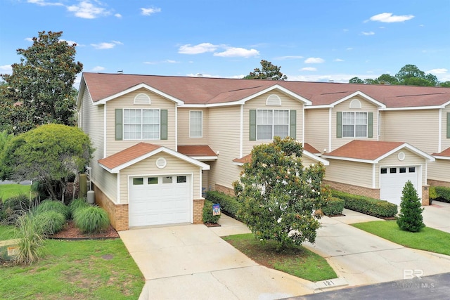 1517 Regency Rd Unit 121, Gulf Shores, AL 36542 - view of front of home with brick siding, an attached garage, and driveway