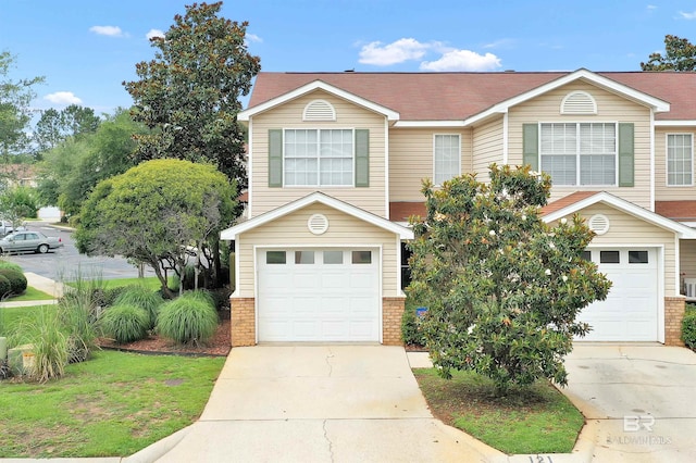 1517 Regency Rd Unit 121, Gulf Shores, AL 36542 - view of front of property with a garage, driveway, and brick siding
