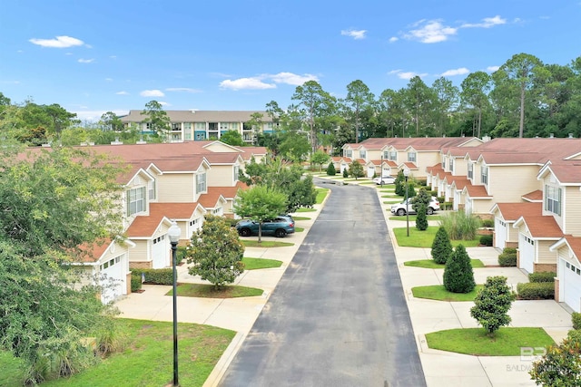 1517 Regency Rd Unit 121, Gulf Shores, AL 36542 - surrounding community with a residential view, concrete driveway, and a garage