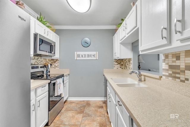 1517 Regency Rd Unit 121, Gulf Shores, AL 36542 - kitchen with stainless steel appliances, a sink, ornamental molding, decorative backsplash, and white cabinetry