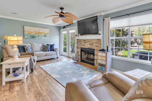 1517 Regency Rd Unit 121, Gulf Shores, AL 36542 - living room featuring crown molding, ceiling fan, a fireplace, and wood finished floors