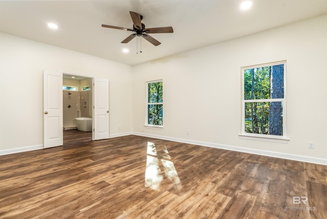 unfurnished bedroom featuring ceiling fan, dark wood-type flooring, and multiple windows