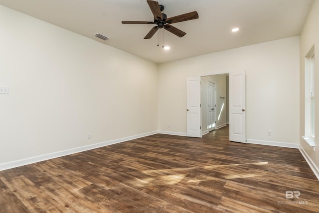 unfurnished room featuring dark hardwood / wood-style floors and ceiling fan