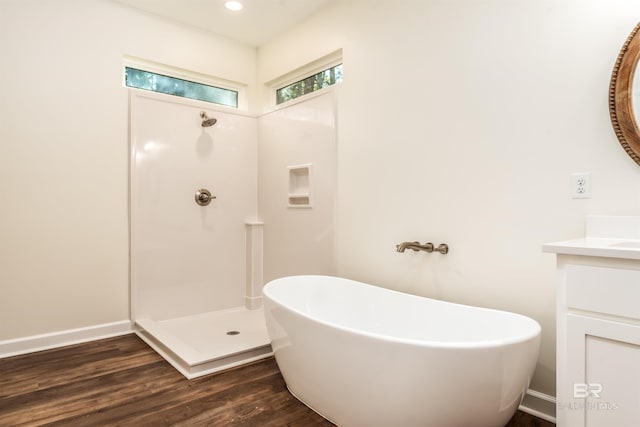 bathroom with vanity, separate shower and tub, and wood-type flooring