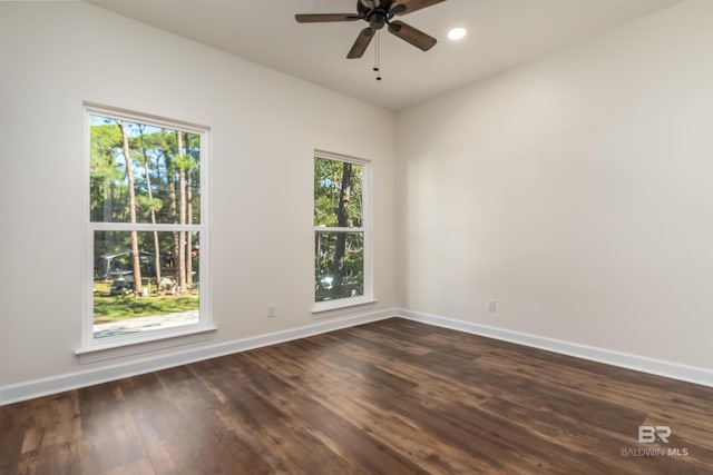 unfurnished room with dark hardwood / wood-style floors, ceiling fan, and a wealth of natural light