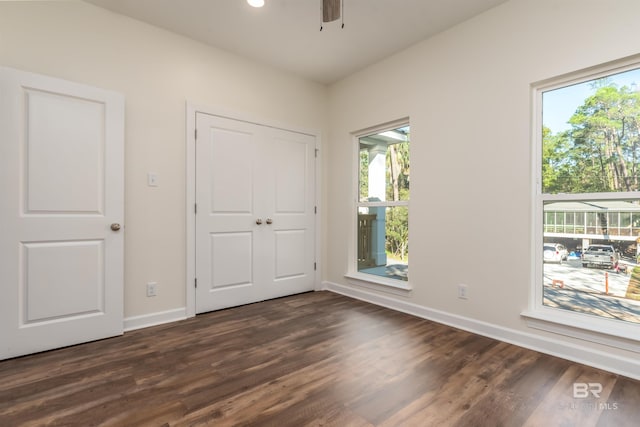 unfurnished bedroom with dark hardwood / wood-style flooring