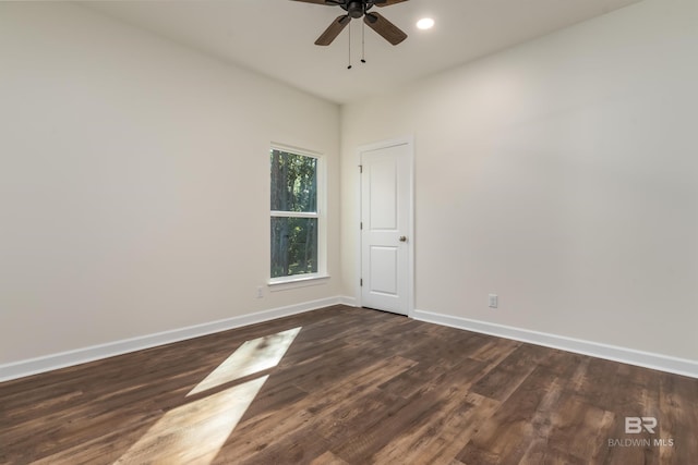 empty room with ceiling fan and dark wood-type flooring