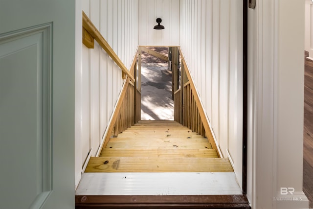 staircase with hardwood / wood-style floors