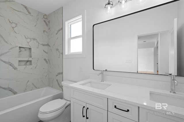 full bathroom featuring tiled shower / bath combo, vanity, and toilet