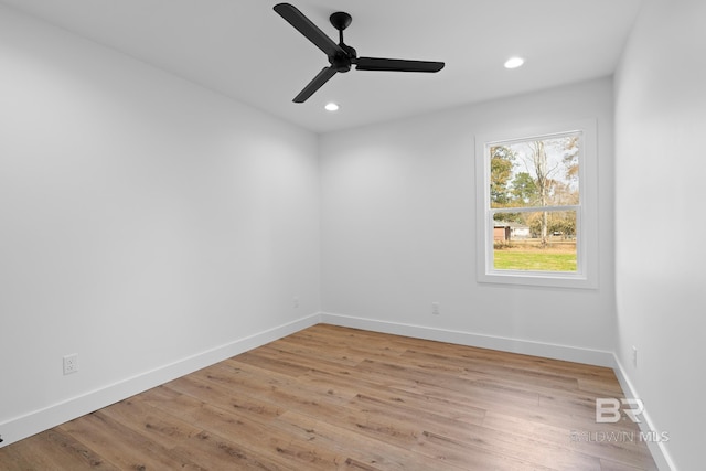 empty room with ceiling fan and light wood-type flooring