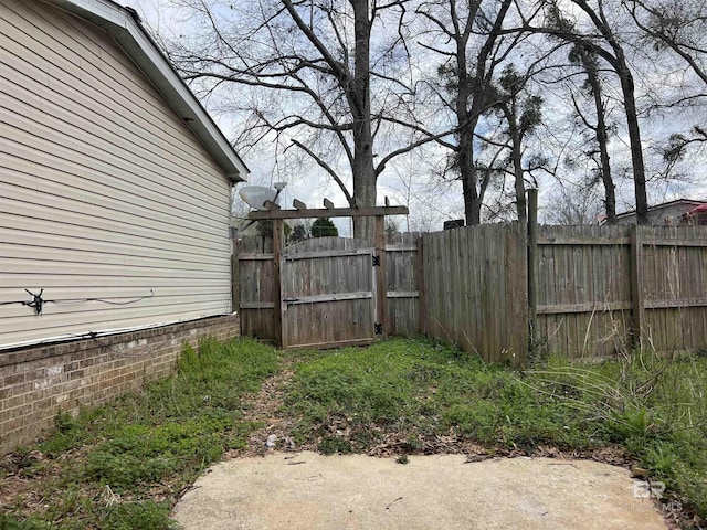 view of yard featuring fence and a gate