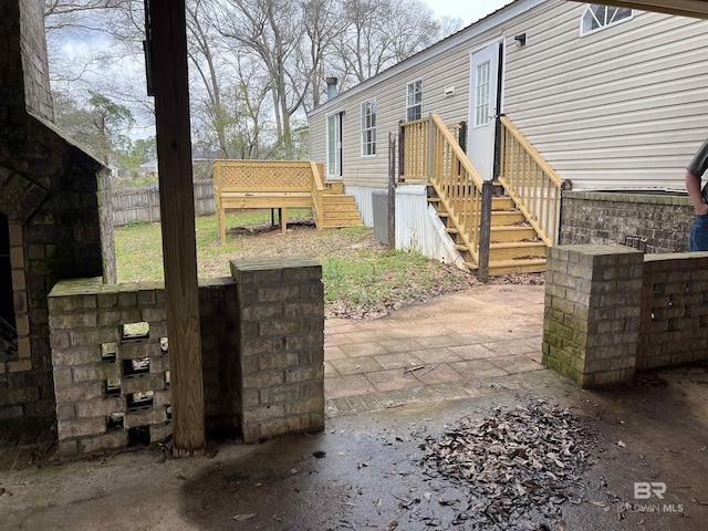 view of patio with fence and a deck