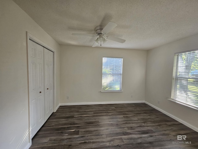 524 Linda Ln, Saraland, AL 36571 - unfurnished bedroom with dark wood-type flooring, a closet, a textured ceiling, ceiling fan, and baseboards