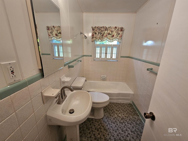 524 Linda Ln, Saraland, AL 36571 - bathroom featuring tile walls, a tub, toilet, a wainscoted wall, and a shower