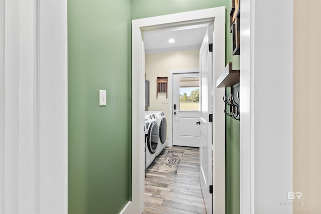 laundry room featuring cabinet space, light wood finished floors, washer and dryer, and recessed lighting