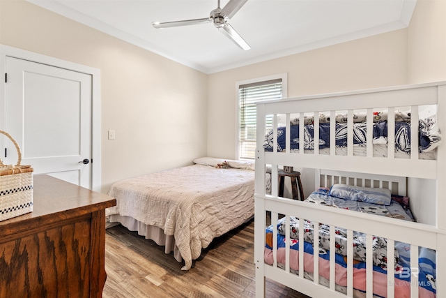 bedroom with ornamental molding, wood finished floors, and a ceiling fan