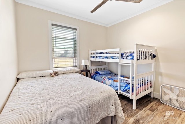 bedroom featuring crown molding, ceiling fan, and wood finished floors