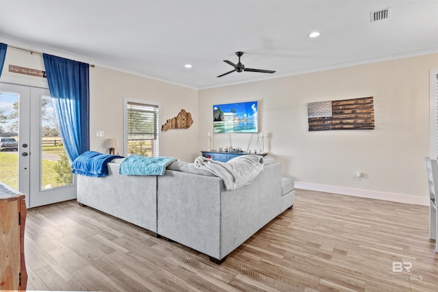 living room with french doors, recessed lighting, ornamental molding, wood finished floors, and baseboards