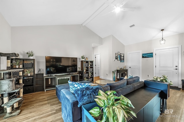 living room featuring ceiling fan, light hardwood / wood-style floors, beam ceiling, and high vaulted ceiling