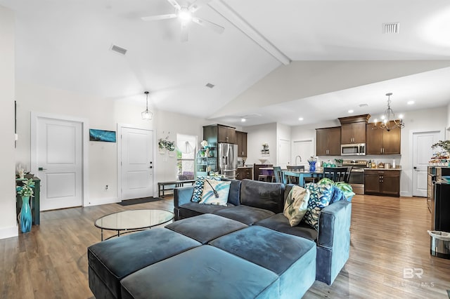 living room with hardwood / wood-style flooring, ceiling fan with notable chandelier, beamed ceiling, and high vaulted ceiling