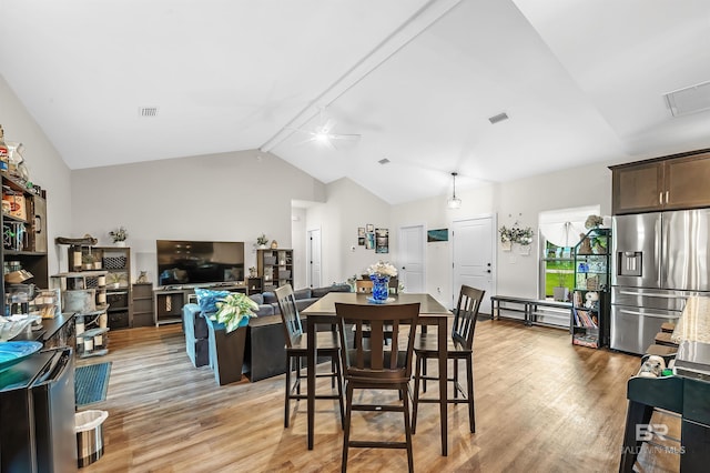 dining room featuring light wood-type flooring, ceiling fan, and lofted ceiling