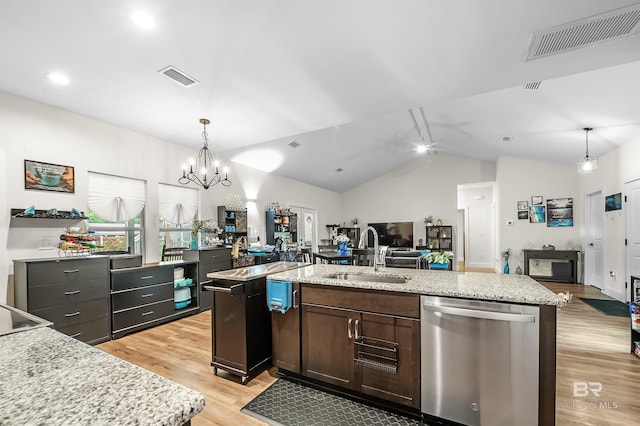 kitchen with a sink, visible vents, open floor plan, and stainless steel dishwasher