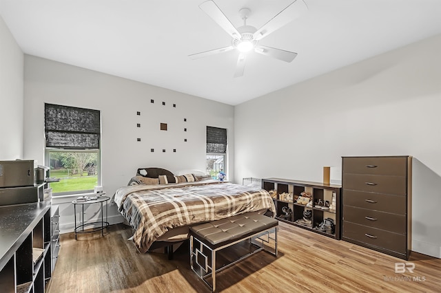 bedroom with a ceiling fan and wood finished floors