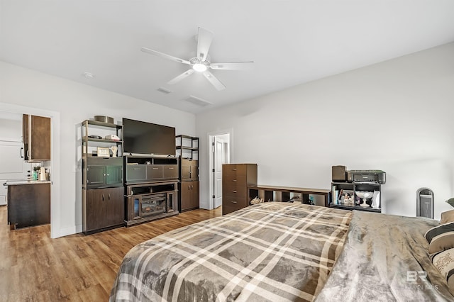 bedroom with ceiling fan and light wood-type flooring