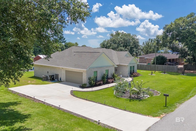 view of front of house with central air condition unit, an attached garage, concrete driveway, and a front yard