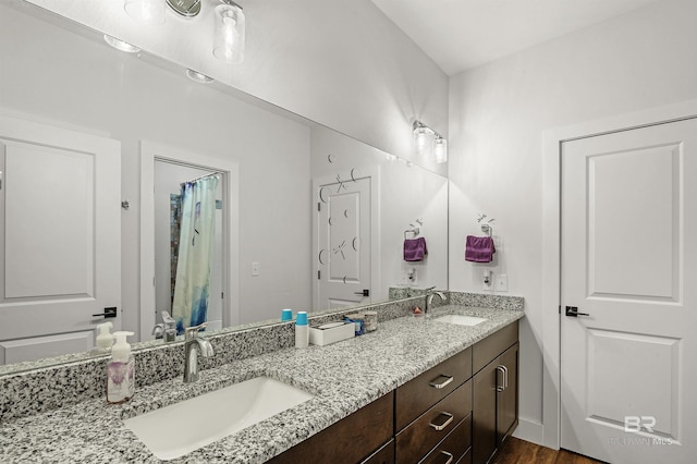 bathroom featuring double vanity and a sink