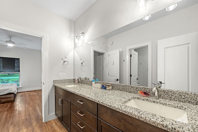 bathroom with hardwood / wood-style floors, vanity, and ceiling fan