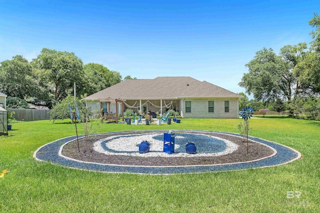 rear view of property with a lawn