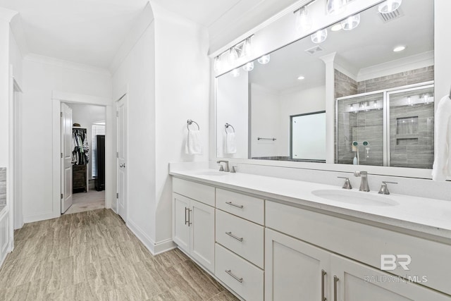 bathroom featuring walk in shower, ornamental molding, and vanity