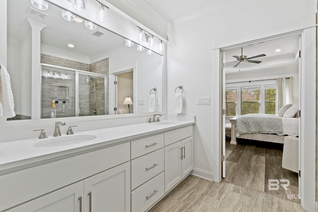 bathroom featuring an enclosed shower, crown molding, vanity, hardwood / wood-style flooring, and ceiling fan