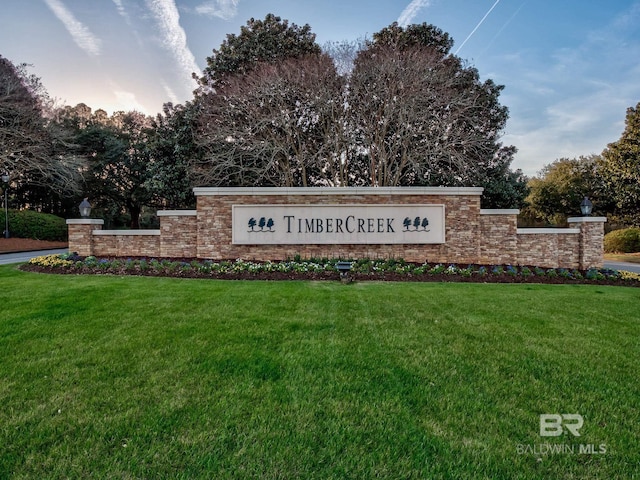 community / neighborhood sign with a lawn