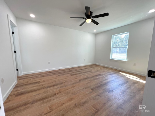 unfurnished room featuring a ceiling fan, recessed lighting, baseboards, and wood finished floors