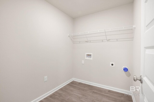 laundry room with washer hookup, electric dryer hookup, wood finished floors, laundry area, and baseboards