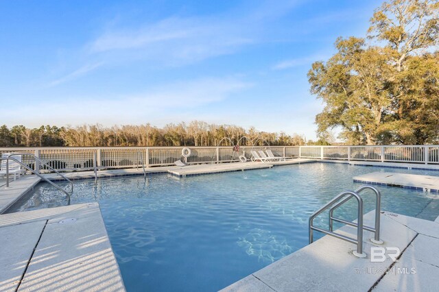 view of swimming pool featuring a fenced in pool and a patio area