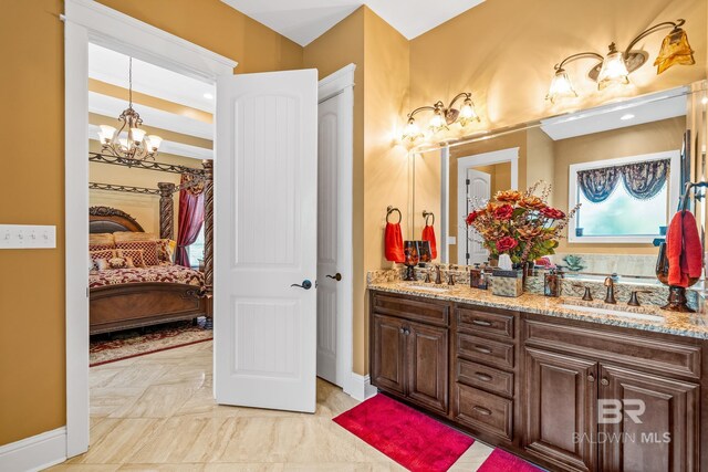10128 Alder Ave, Spanish Fort, AL 36527 - ensuite bathroom with a chandelier, double vanity, and baseboards