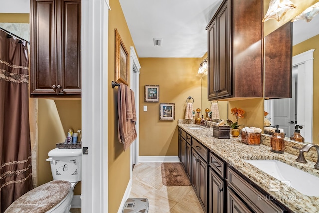10128 Alder Ave, Spanish Fort, AL 36527 - bathroom featuring double vanity, toilet, marble finish floors, baseboards, and a shower with curtain