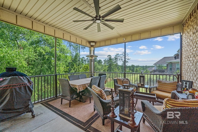 10128 Alder Ave, Spanish Fort, AL 36527 - sunroom / solarium featuring ceiling fan, outdoor lounge area, and view of wooded area