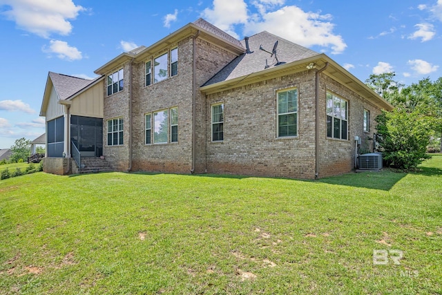 10128 Alder Ave, Spanish Fort, AL 36527 - view of side of property featuring brick siding, central AC unit, a yard, a sunroom, and board and batten siding