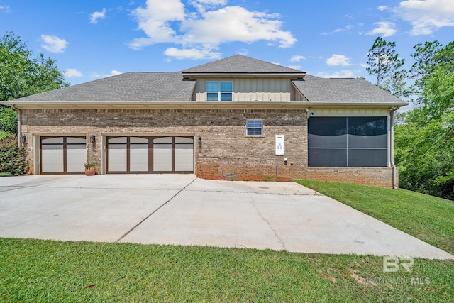 10128 Alder Ave, Spanish Fort, AL 36527 - view of front facade featuring driveway, brick siding, a front lawn, an attached garage, and a shingled roof