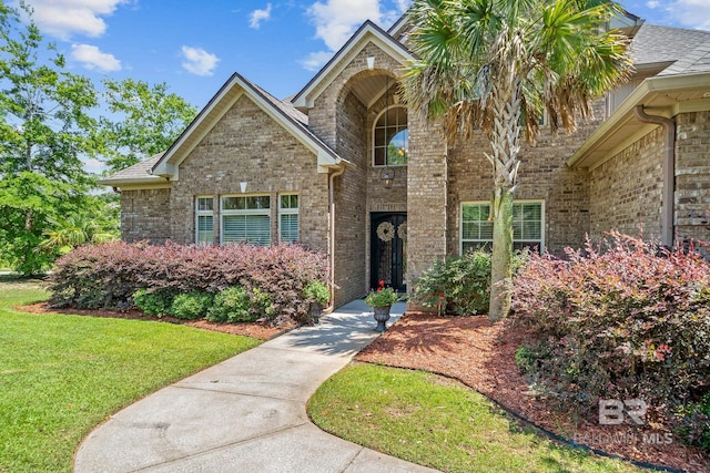 10128 Alder Ave, Spanish Fort, AL 36527 - traditional-style house with brick siding, a front lawn, and roof with shingles