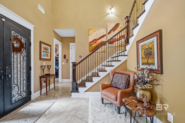 10128 Alder Ave, Spanish Fort, AL 36527 - foyer entrance with a towering ceiling, stairway, baseboards, and marble finish floors