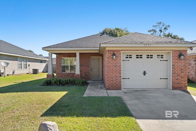 view of front of property featuring central AC unit, a garage, driveway, a front yard, and brick siding