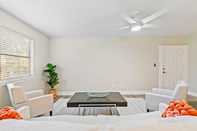 living room featuring hardwood / wood-style floors and ceiling fan